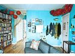 The red tissue-paper flowers were created the same way as the white ones in the bedroom. "When you have really bright colors next to each other that are not analogous, the best thing to do is put some of the opposing colors in each room," explains Gulledg
