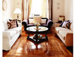 "We've had to mesh styles," Flora concedes of living with three other people. As a result, her spacious living room contains three contrasting couches---each brought to the apartment by a different roommate---that she unified with matching patterned pillo