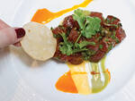 Rough-cut tuna nachos at Mesa GrillBobby Flay's Southwestern eatery delivers this high-low hybrid of nachos and tuna tartare. Use the chips to scoop tender hunks of raw fish, punched up by briny capers and slicked with avocado crema and mango hot sauce. 1