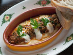 Sausage polenta at Osteria Morini The  return of sweater weather also signals the revival of this  chill-abating indulgence. Chef Michael White's stratospheric version of  creamy polenta is stocked with white pepper and funky Parmesan, spread  with a laye