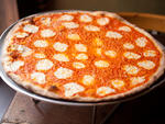 Vodka pizza at RubirosaEach  year seems to spawn a new pretender to NYC's pizza throne, but this  newcomer actually approaches pantheon status. Rubirosa's crisp yet  pliable thin-crust pies have a delicate char and a small ring of  crackerlike crust aroun