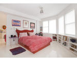 Like everything else in the apartment, the couple's bedroom is customized to fit their funky aesthetic. "I designed the built-ins to utilize the most amount of space I could," Zulver points out. That includes the base of the bed, which offers hidden drawe