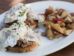 Pulled pork with an Asiago biscuit, poacked eggs, country gravy and potatoes at Maximilliano