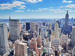 New York City Manhattan midtown aerial panorama view with skyscrapers and blue sky in the day.