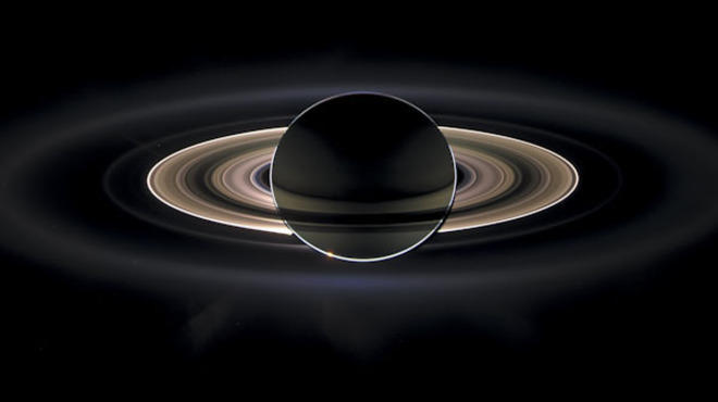 Backlit by the sun, Saturn and its rings were photographed by the Cassini probe in 2006.