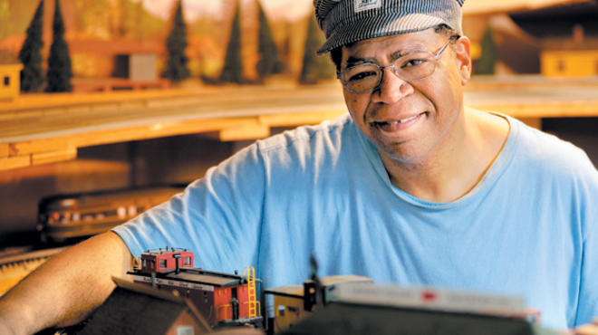 HOUSE OF TRAIN Powell tinkers with a fleet of toy choo-choos in his Morton Grove basement.