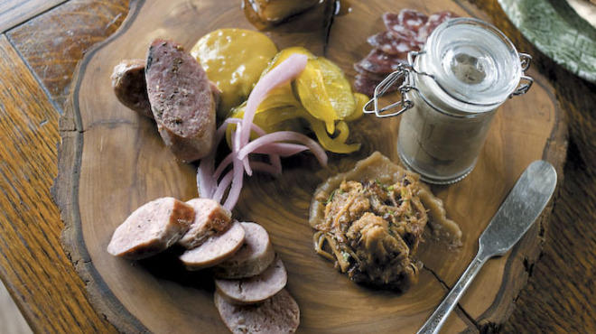 CHARCUTERIE plate with Pork Jowl, Tuscan Salami, Rabbit Liver Pate, Pork Rillette with apple butter, cumberland sausage, ;amb sausage, beer mustard, bread and butter pickles and pickled red onion
