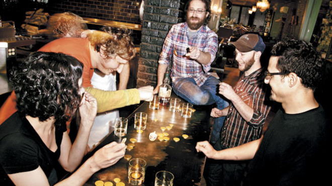 Jason Vincent (in plaid) leads his chefs in a game of dreidel.