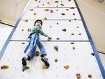 Giovani Cabrera, 7, climbs the rock wall at Broadway Armory Park in Chicago.