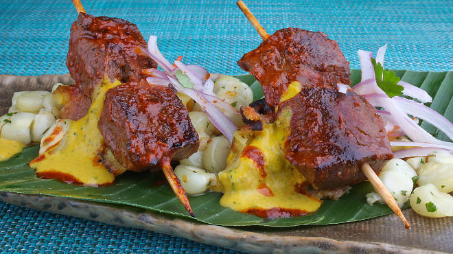 Tanta's anticucho de corazon is served with chimichurri, corn and huacatay herbs.