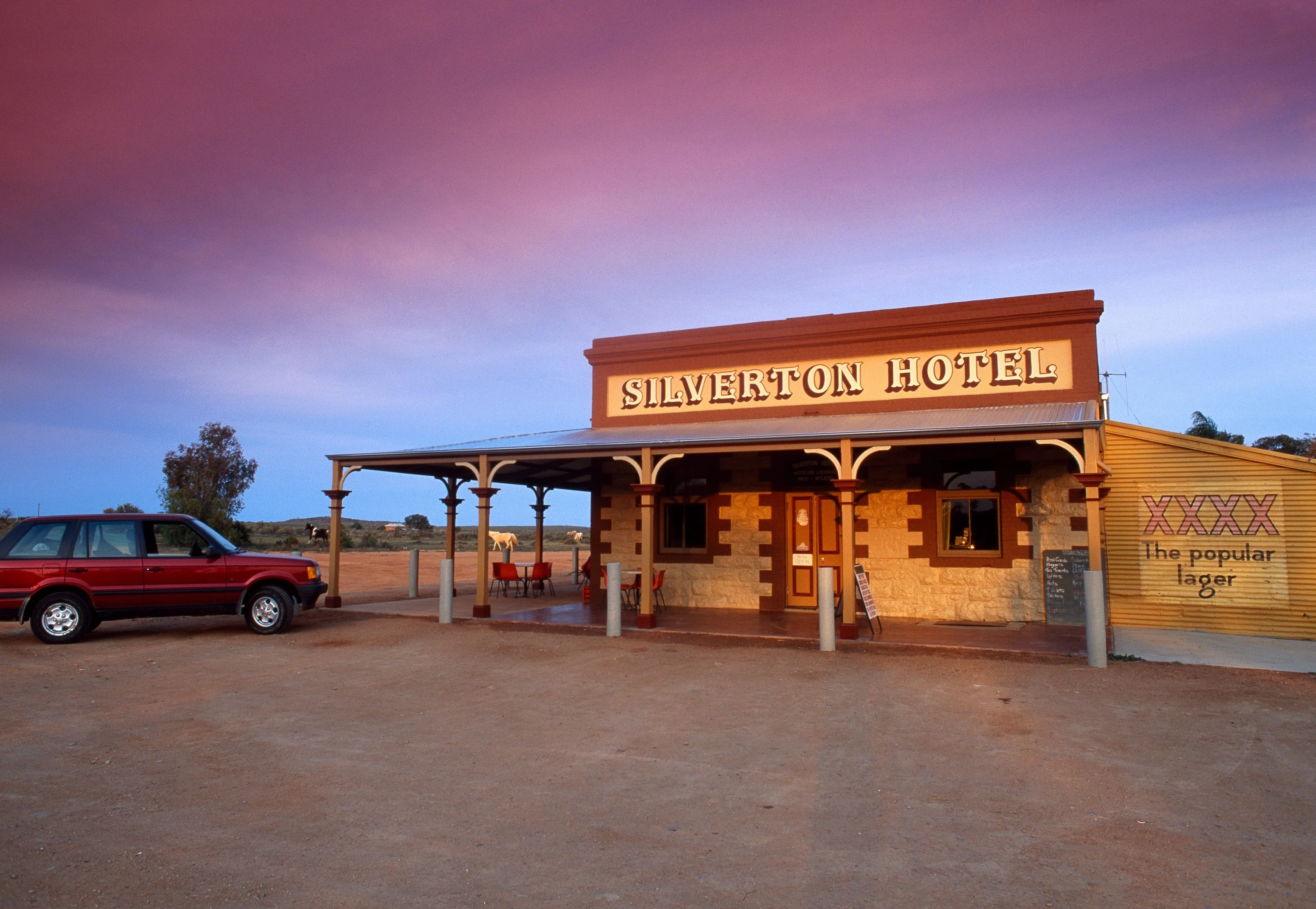 Exterior of old-timey outback pub at sunset 