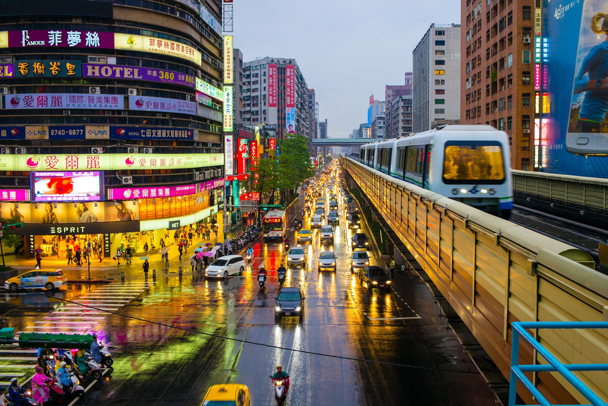Street view of Taipei with metro train on the rail 
