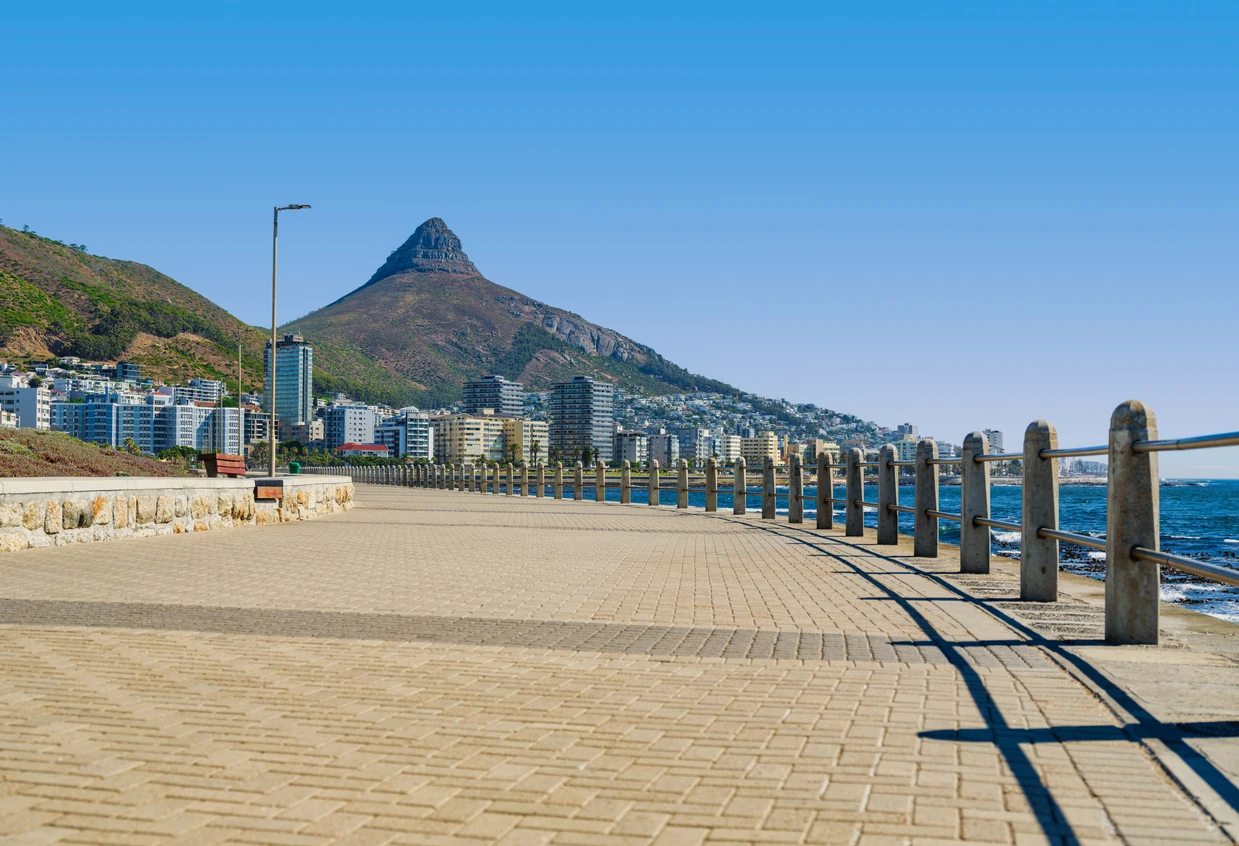 Low angle view of Sea Point Promenade with the iconic Lion's Head Mountain prominently in the background, Cape Town, South Africa