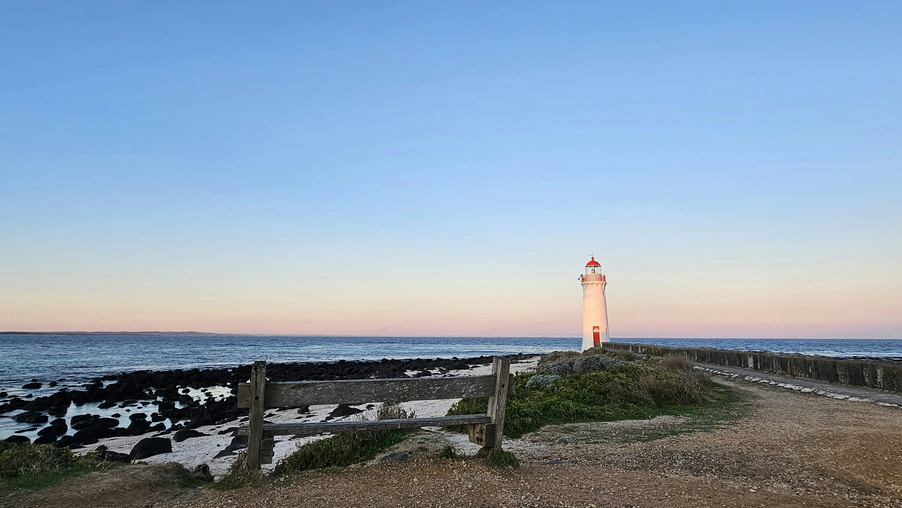 A light house sitting on top of a sandy beach