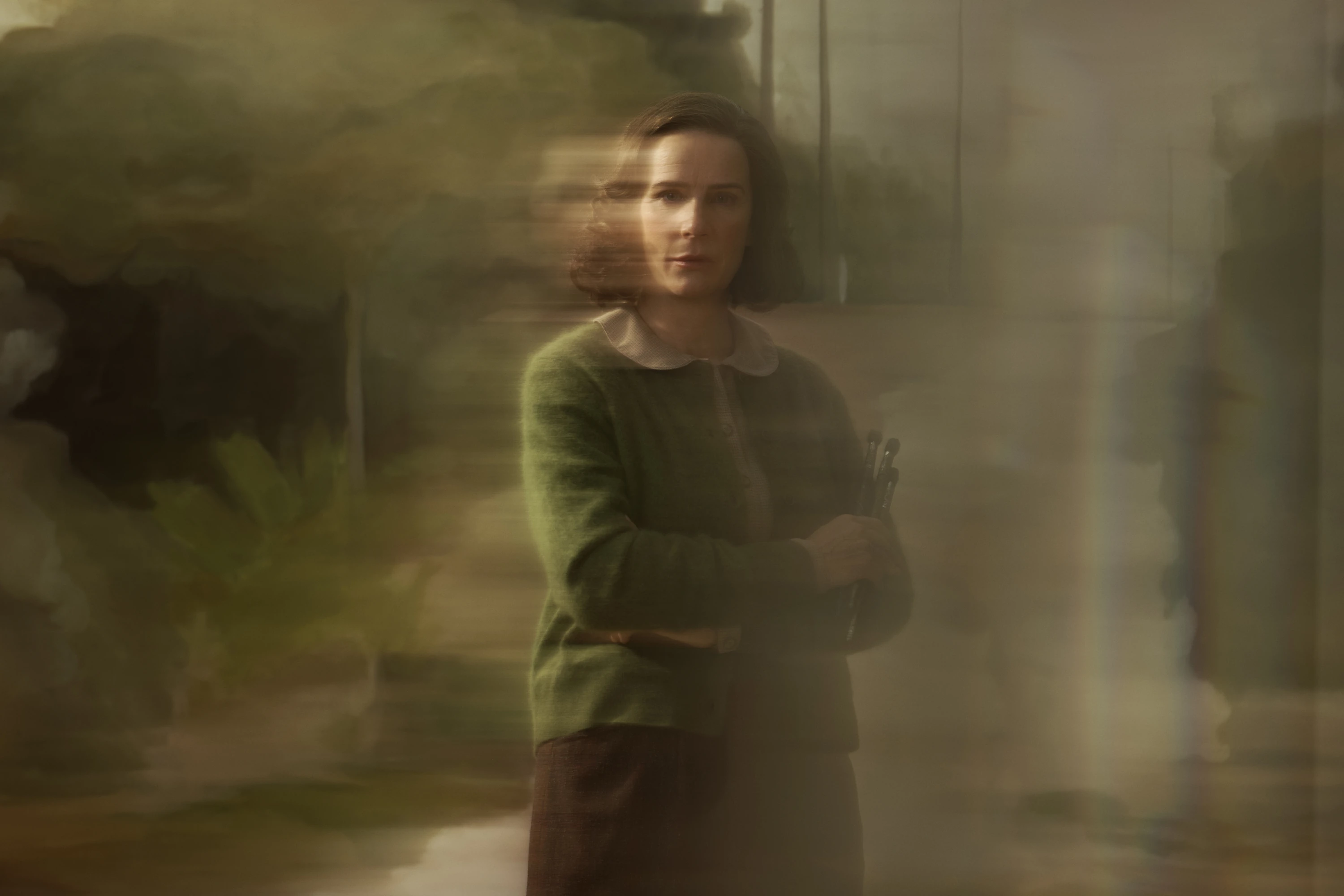 woman with arms folded in a shadowy type of photo