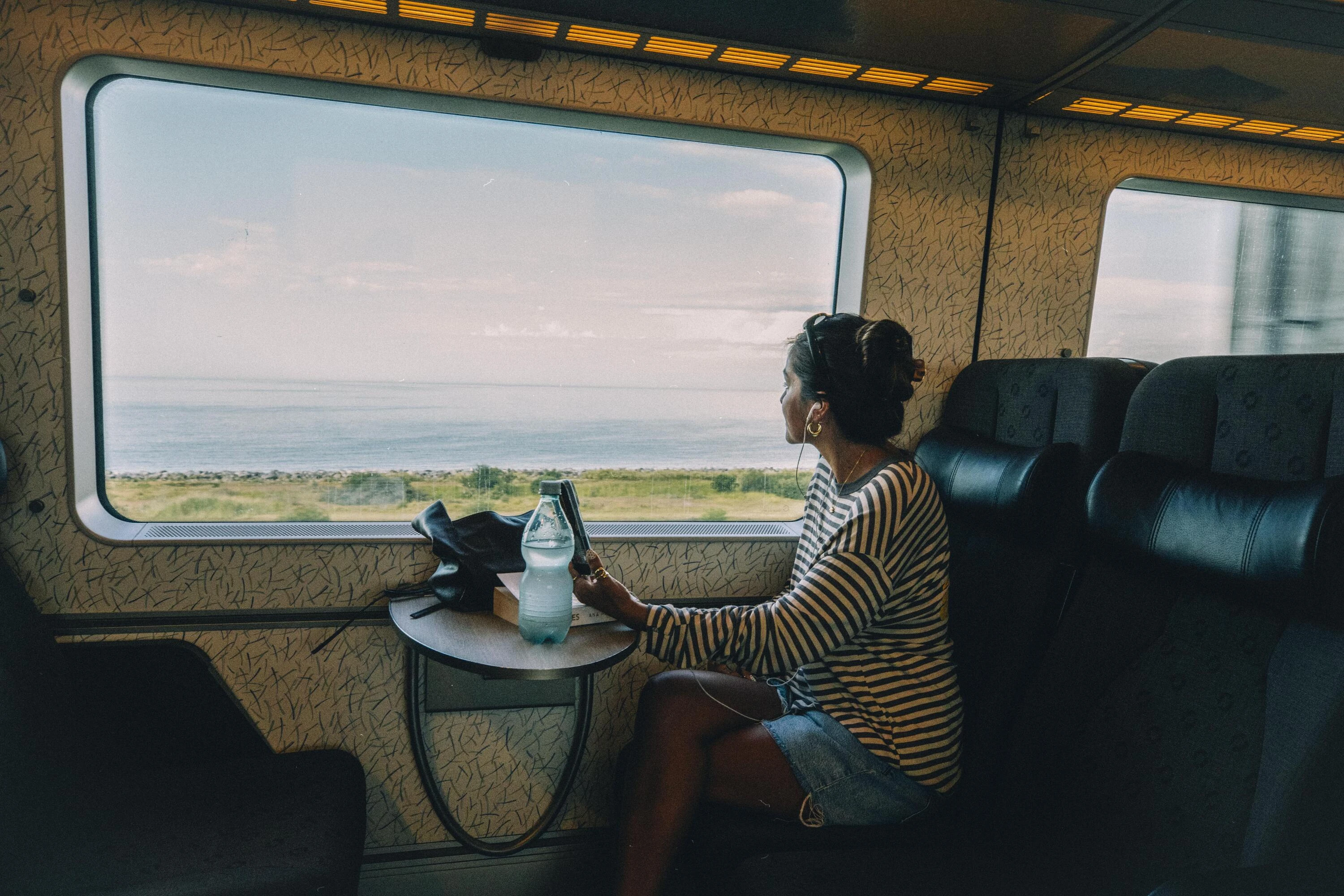 Woman looking out train window