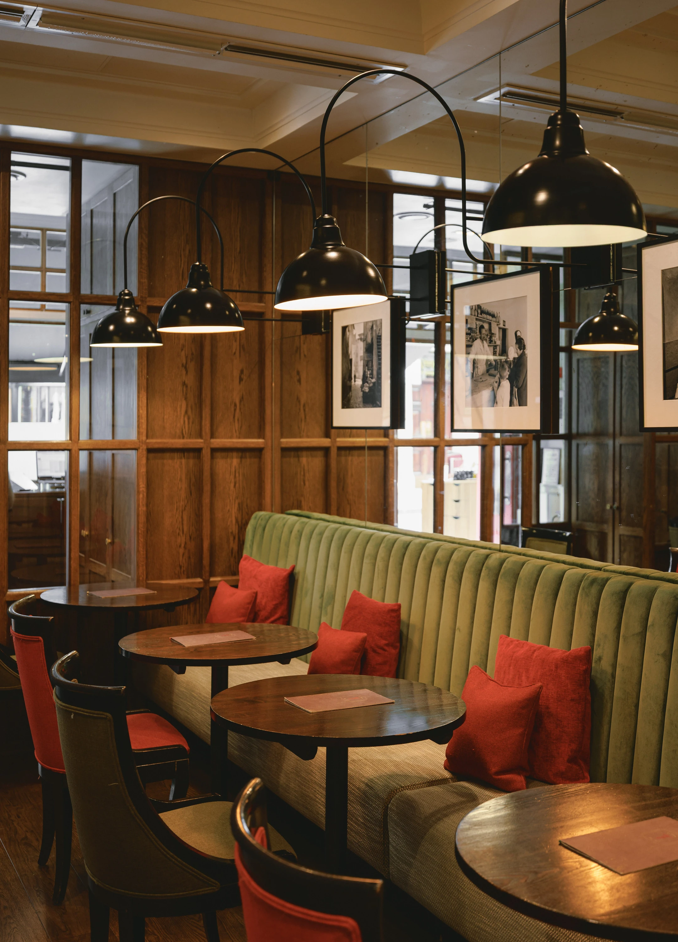 Green banquette seating with red cushions at Franco&rsquo;s 