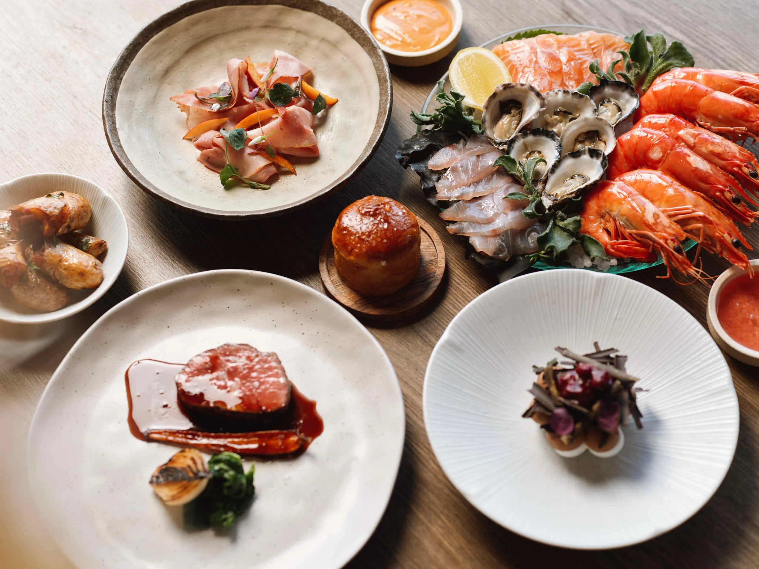 A table stocked with seafood, steak and more for Park Hyatt's Christmas Day menu