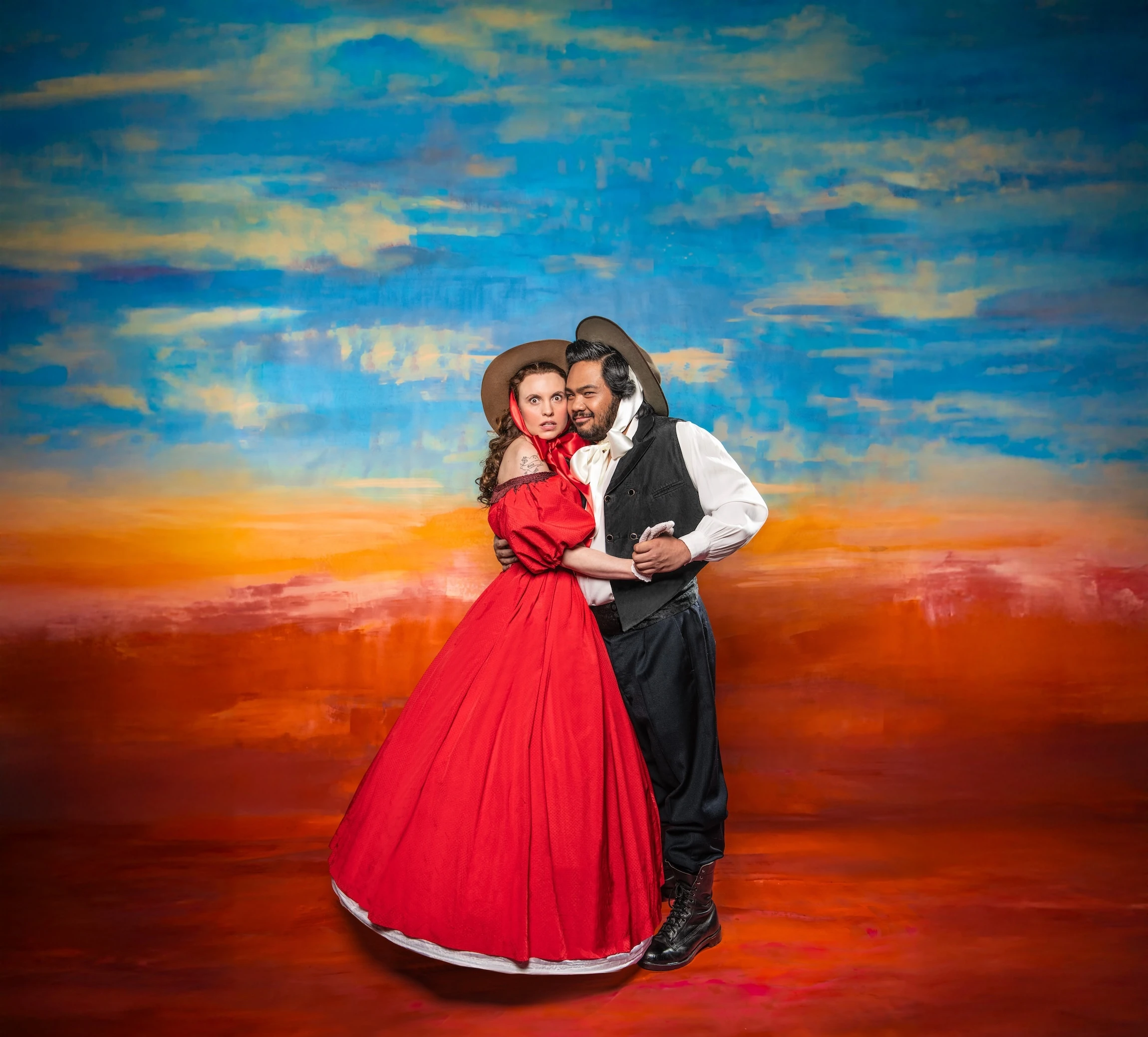 woman dressed in red as Scarlett O'Hara and man as Rhett Butler