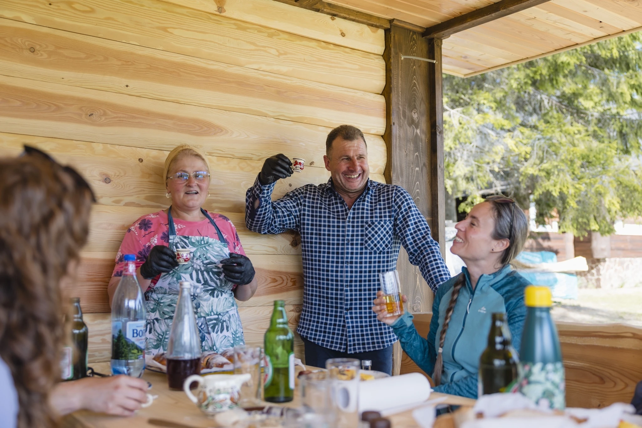 One of the hosts on the Via Transilvanica trail raises a shot of cherry liqueur
