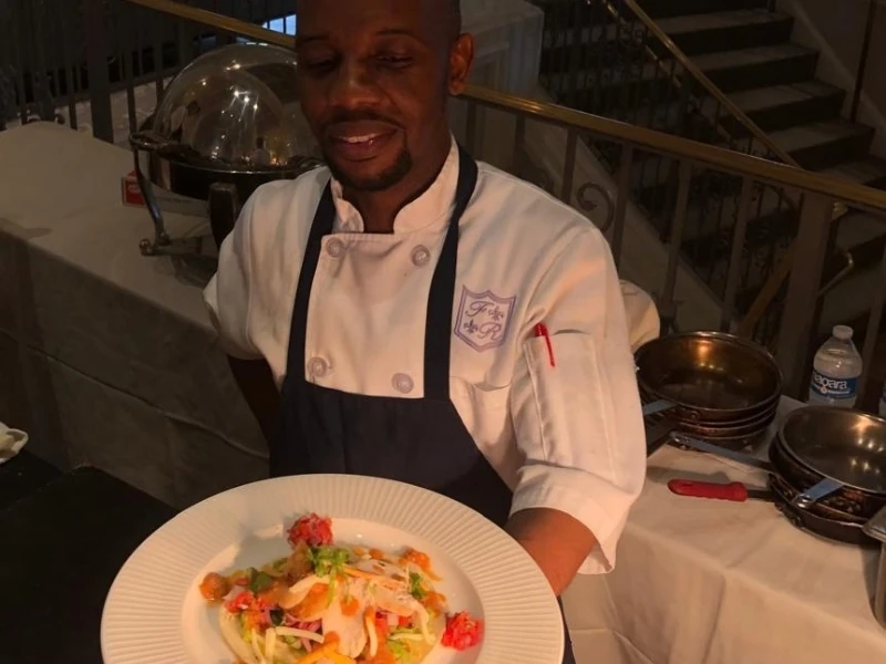 Chef Nelson Makgakoa holding a plate of food in his hands