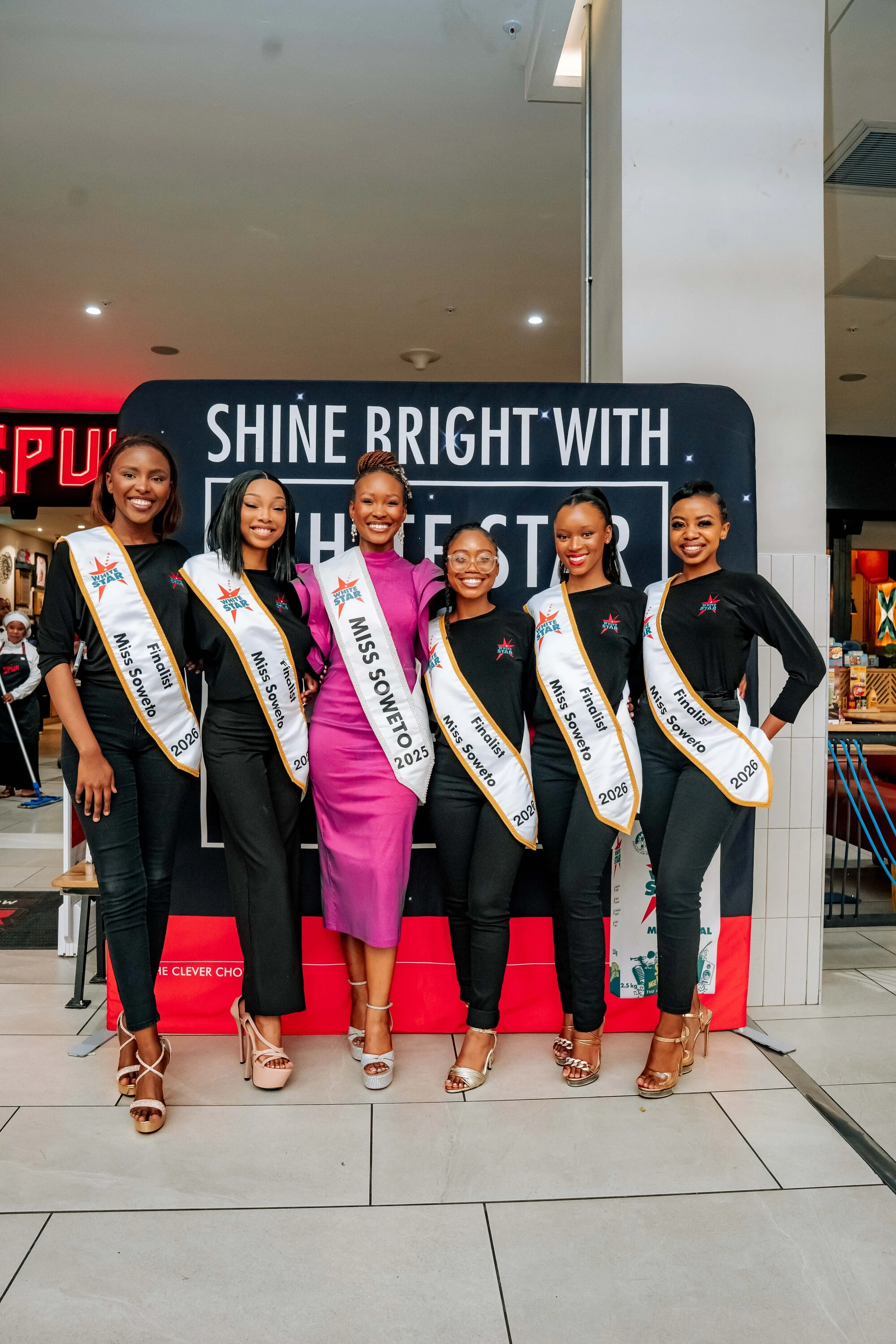 Miss Soweto 2025 Lungile Siyaphi flanked by some of the 2026 finalists. 