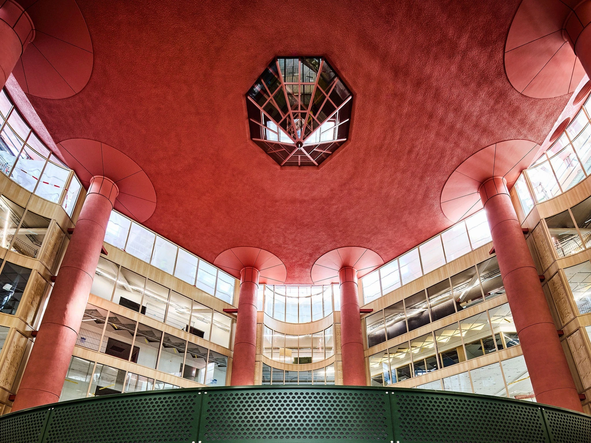 The entrance to S&ouml;derhallarna at night: a red neon sign above a curved, red-lit doorway covered in posters announcing the reopening on 23 October.