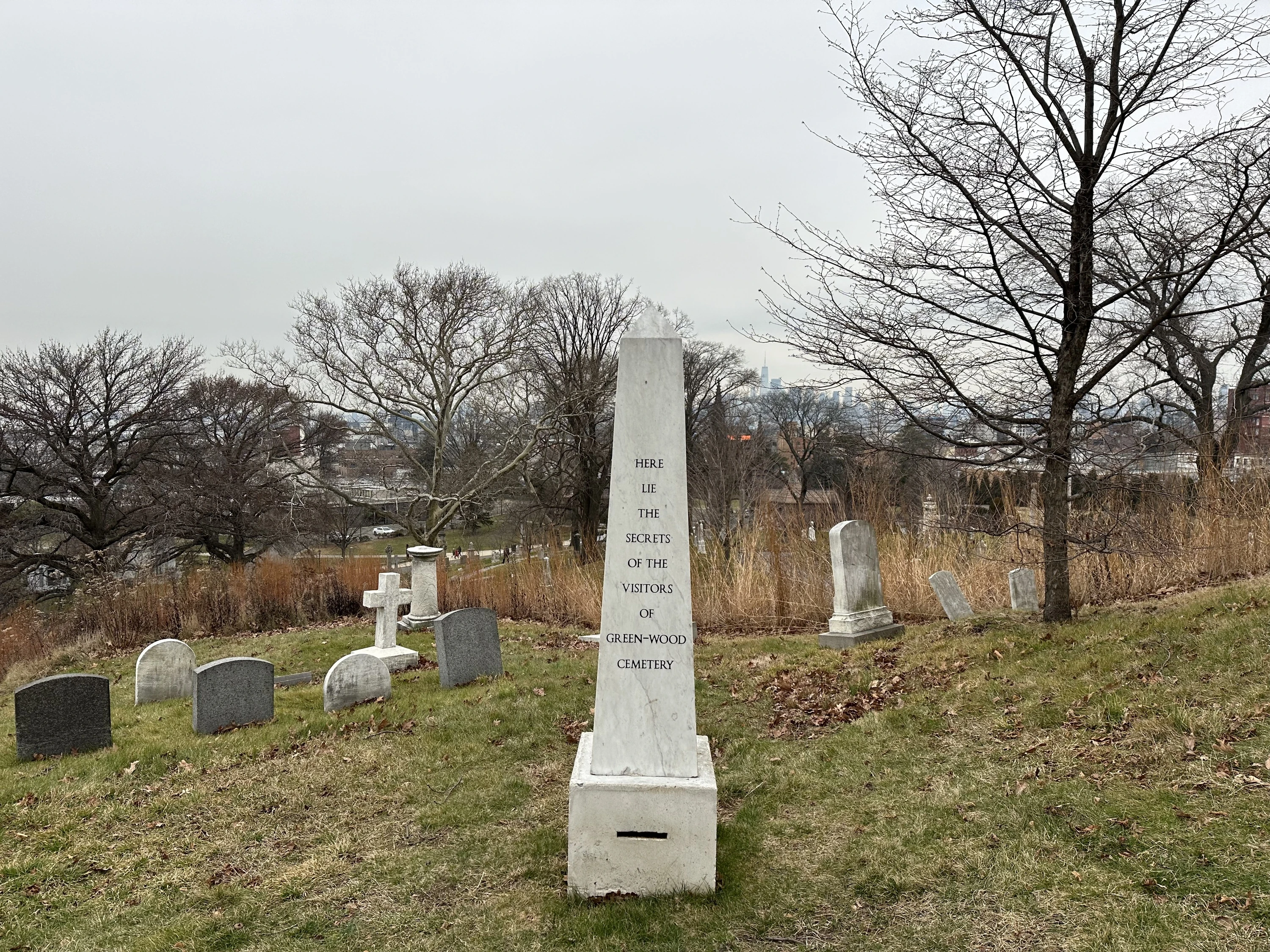 An obelisk-shaped tomb with a mailslot.