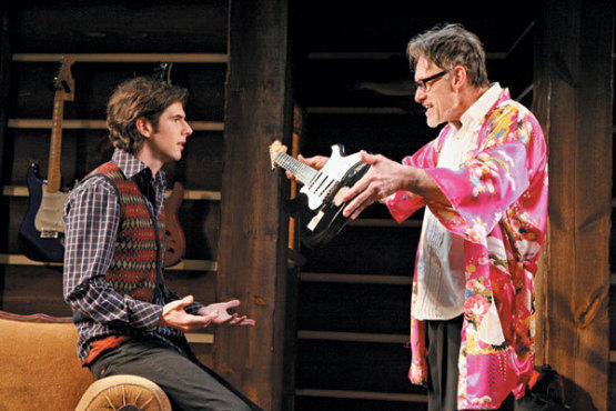 STRUNG OUT Cullen, right, bequeaths a guitar to Gold.