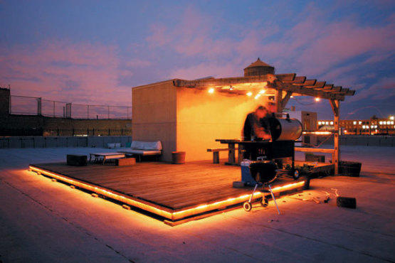 Rooftop grilling with a view of the skyline.