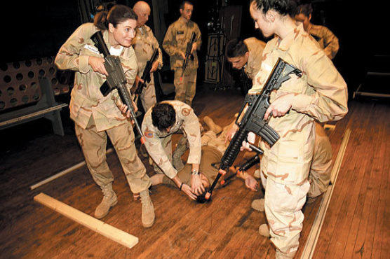 SEARCH AND DESTROY Actors and audience members simulate combat.