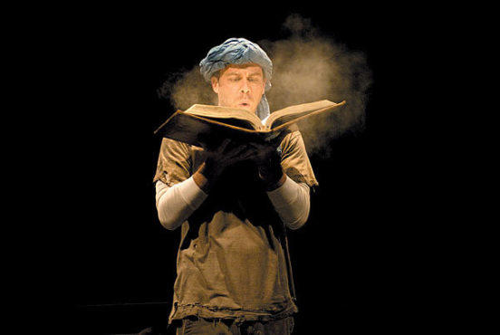 TOME DELIVERY Rauch blows the dust off an ancient book.