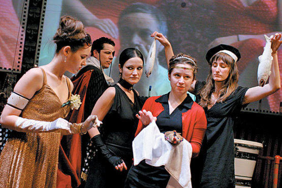 A VIEW TO A GILL Sarah Dahlen, second from right, unwraps a bejeweled fish.