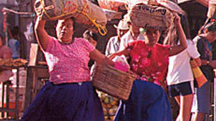 MARKET ECONOMY Zapotec women balance the goods.