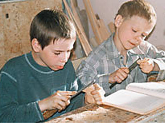 LITTLE MAN, WHITTLE NOW? Spiridonov, right, conducts his own woodworking class LITTLE MAN, WHITTLE NOW? Spiridonov, right, conducts his own woodworking class.