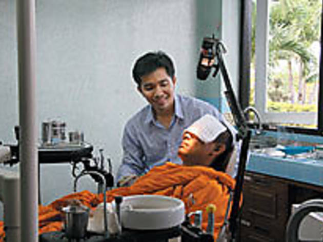 SAY "OM" Cherkam, top, treats a monk SAY "OM" Cherkam, top, treats a monk.