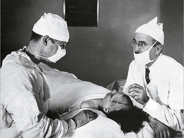 HEAD GAMES Freeman, right, probes a patient's skull HEAD GAMES Freeman, right, probes a patient's skull.