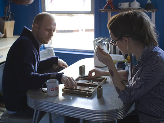 The couple hosts a lot of boozy, vegetarian dinners and game nights in their apartment; backgammon gets especially heated. The couple hosts a lot of boozy, vegetarian dinners and game nights in their apartment; backgammon gets especially heated.