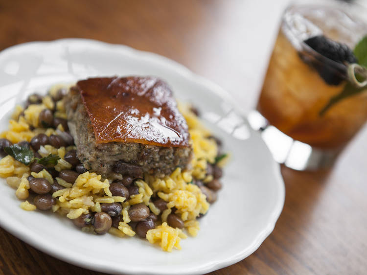 Pernil (roasted pork) with yellow rice and pigeon peas at Botanica