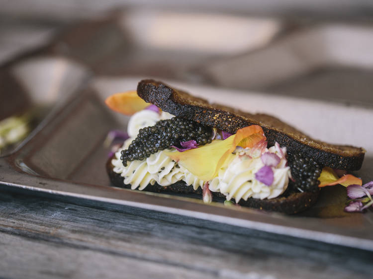 Caviar, whipped butter and flowers on rye at M. Wells Dinette