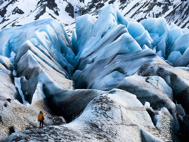 Chasing Ice An Extreme Ice Survey team member checks out a glacier in Chasing Ice.