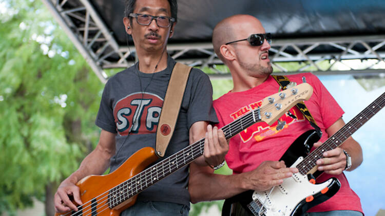 Wrigleyville SummerFest Two guitarists play on an outdoor stage.