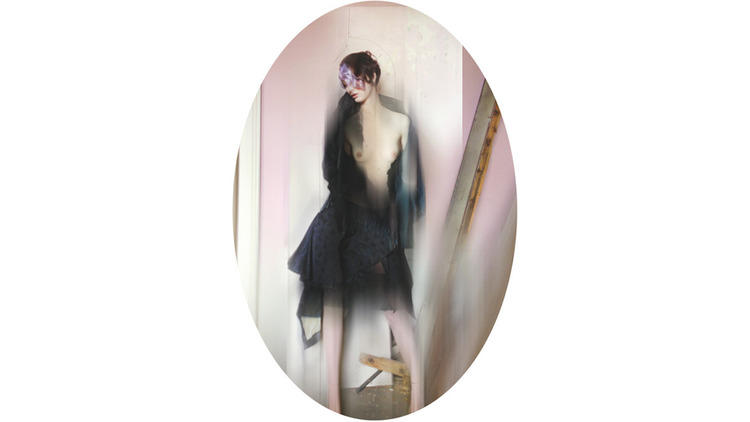 Black frock coat with feather stand up collar and embroidery detailing, silk and feather (© Nick Knight)