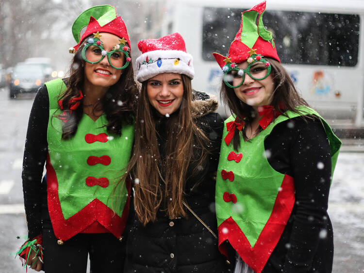 SantaCon 2013 invades NYC Three women dressed up as Elves and Santa