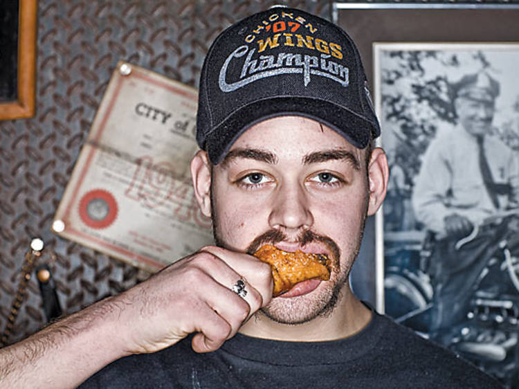 GETTING SAUCED Patrick “Deep Dish” Bertoletti tries the wings at Twisted Spoke.