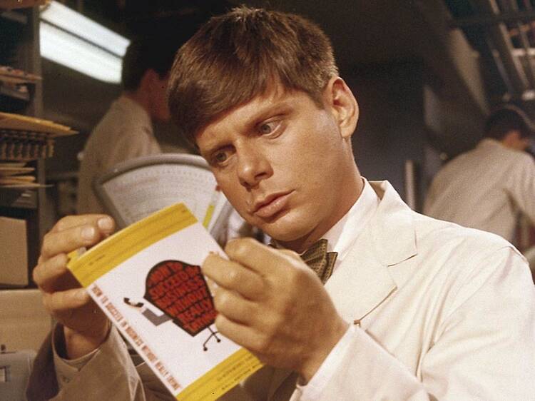 Robert Morse studies up in the 1967 film version of How to Succeed in Business Without Really Trying.