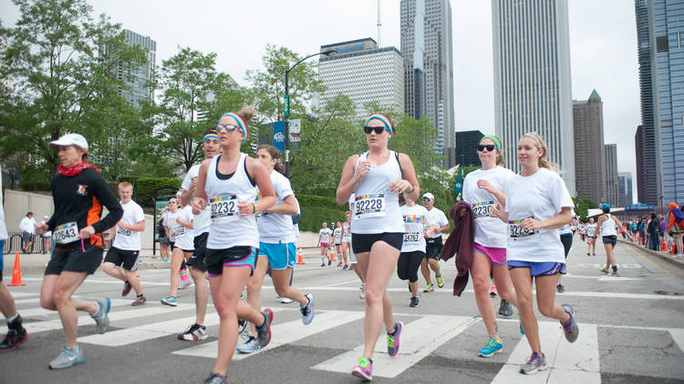 Runners get doused with powdered color at the Color Run 5K through Grant Park on June 8, 2014.