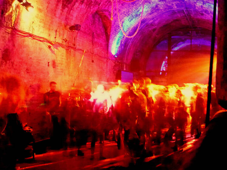 A photo of a party in a tunnel with disco lights.