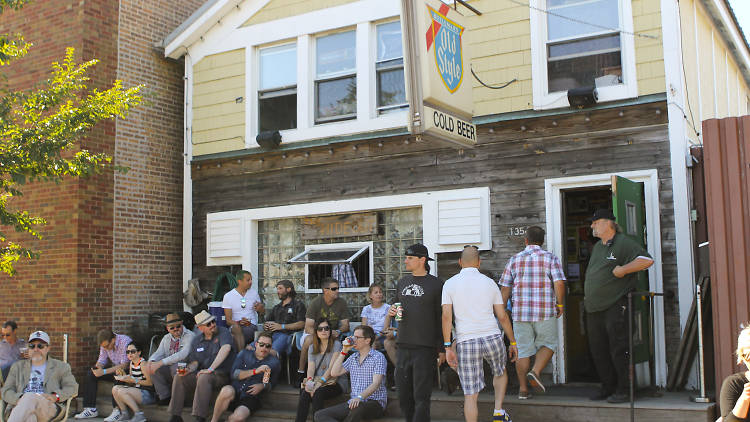 Attendees soak up some sun in a parking lot at the Hideout Block Party and Onion A.V. Fest on September 6, 2014.