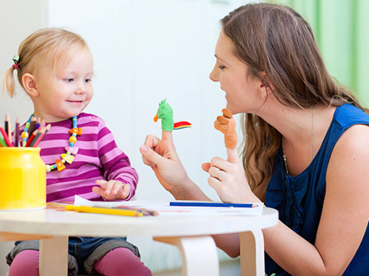 Mother and daughter playing with finger toys